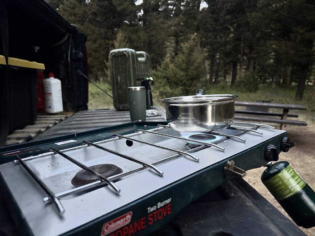 Making coffee in the morning at Red Cliff Campground before heading out to for another BOTG adventure.